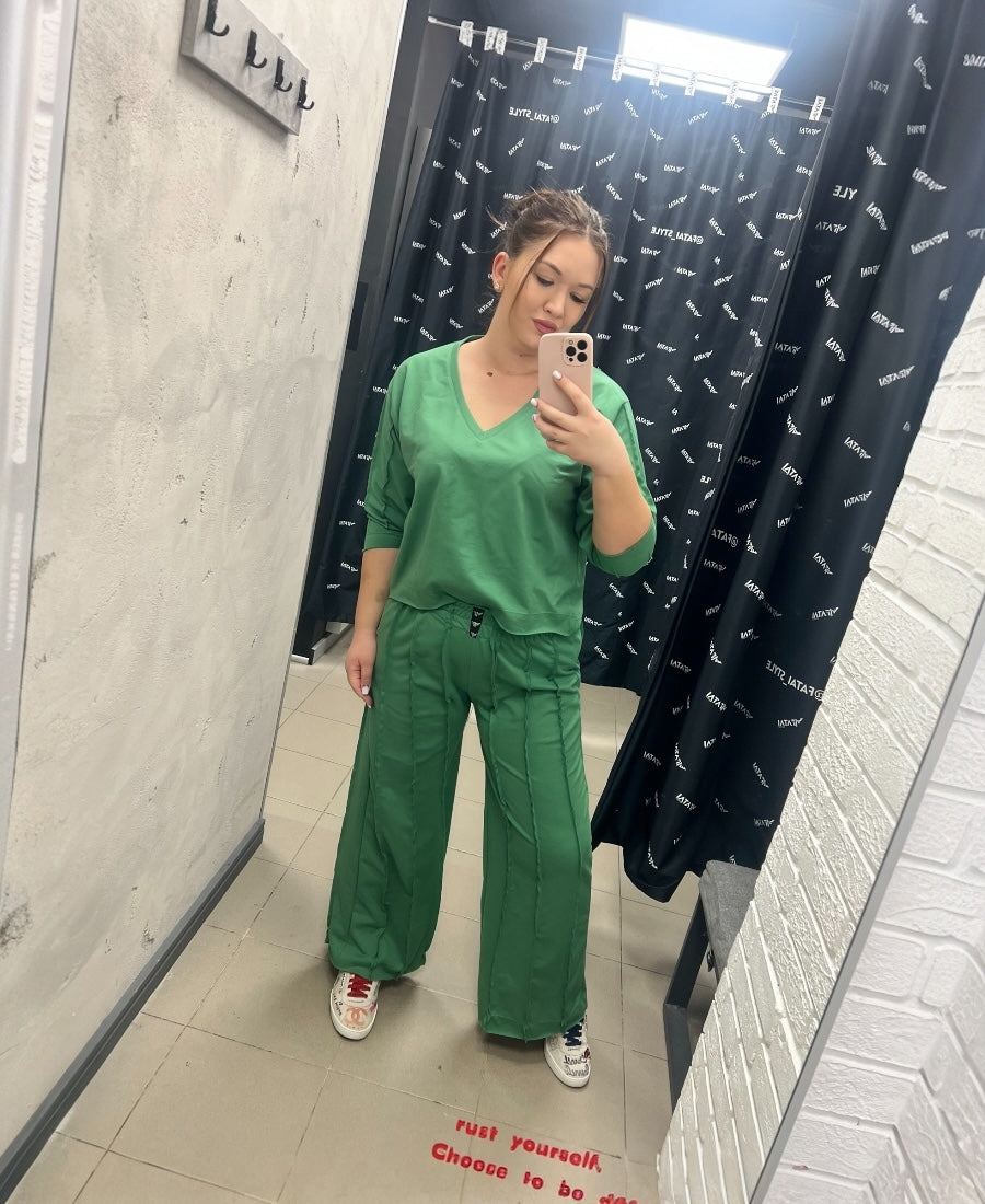 Green tracksuit with multiple cuts
