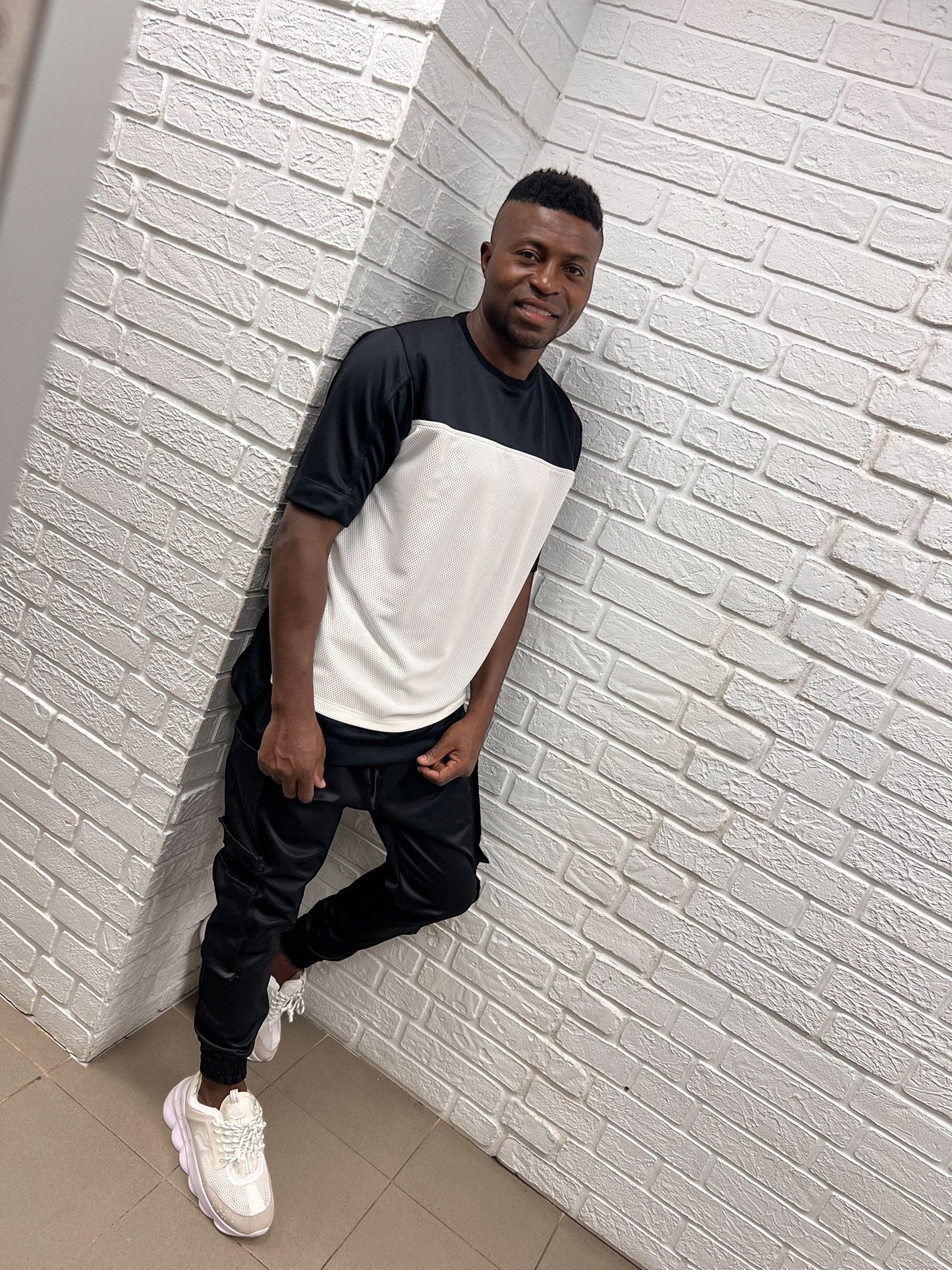 Black trousers made with shiny material and side pockets
