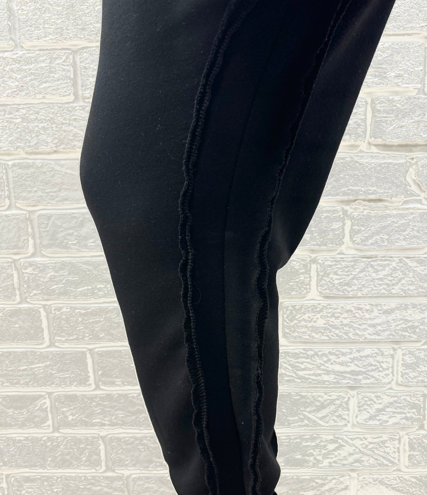 Black trousers with multiple sewings and zips, large