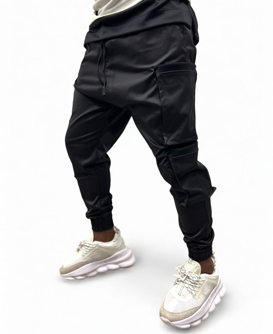 Black trousers made with shiny material and side pockets