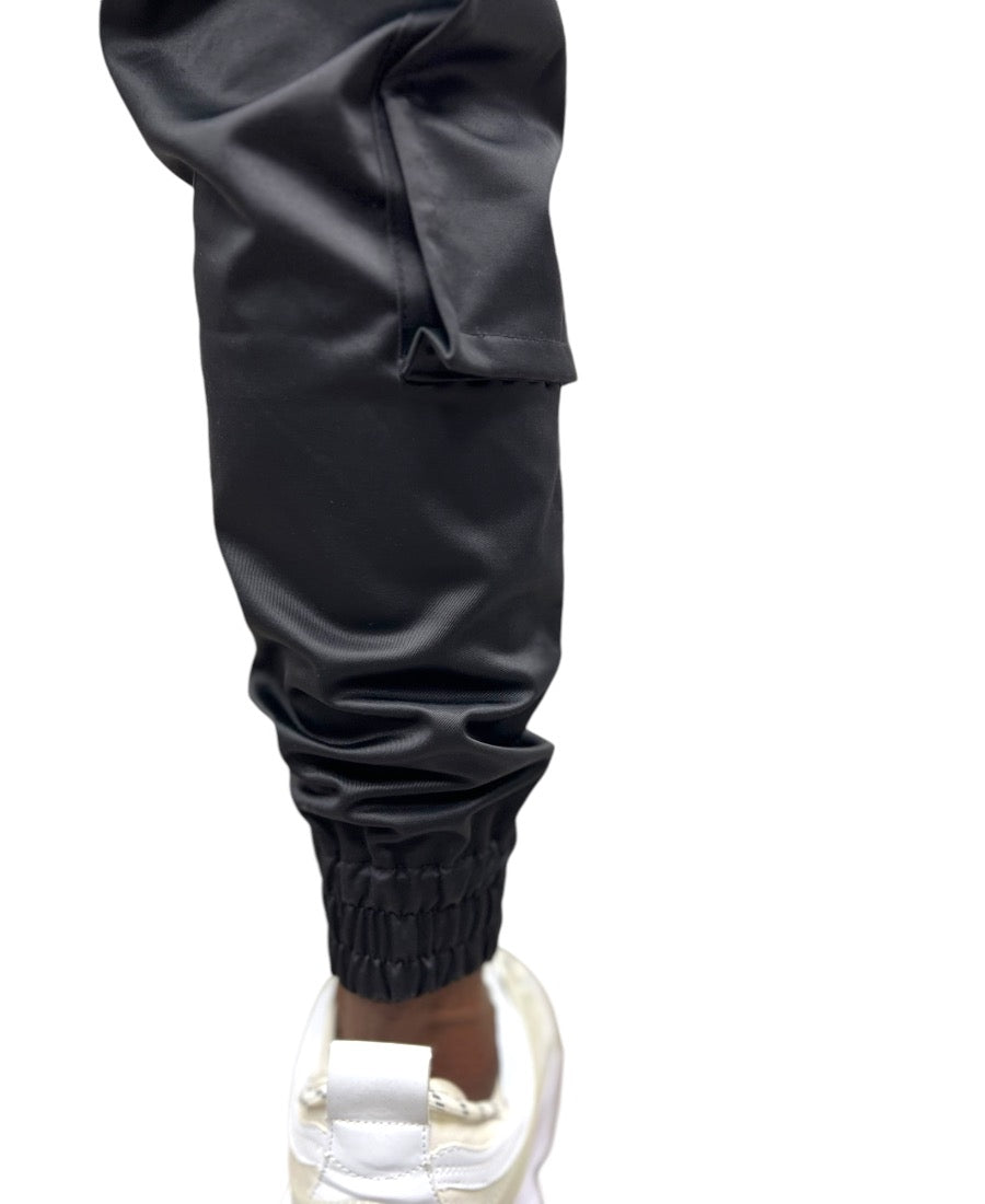 Black trousers made with shiny material and side pockets