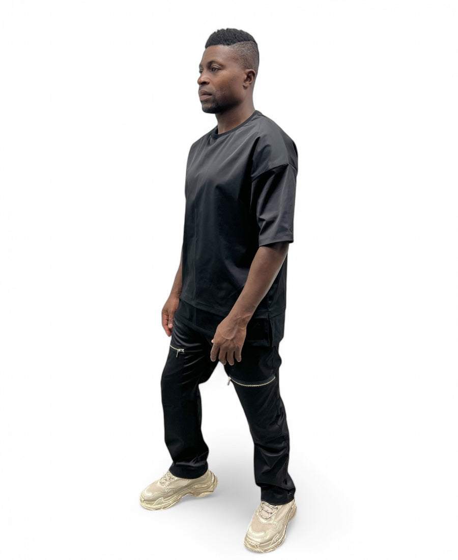 Black trousers made with shiney material, large and with zips
