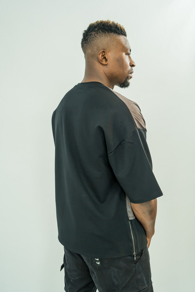 Black t-shirt combined with different material and with zip on the hand