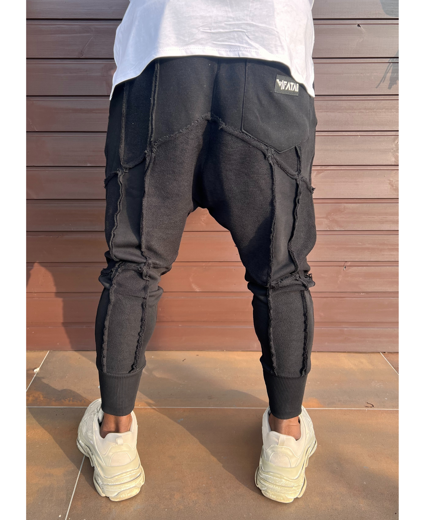 Black trousers with multiple sewings