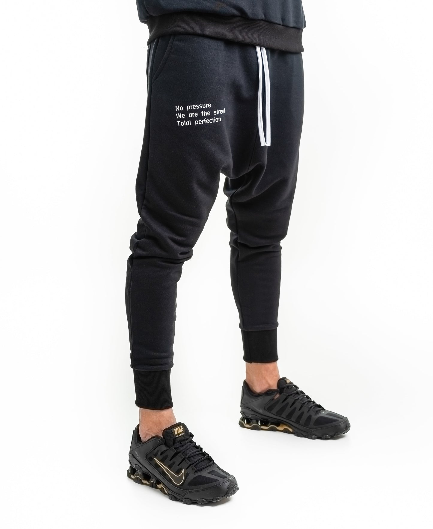 Black trousers with printed text