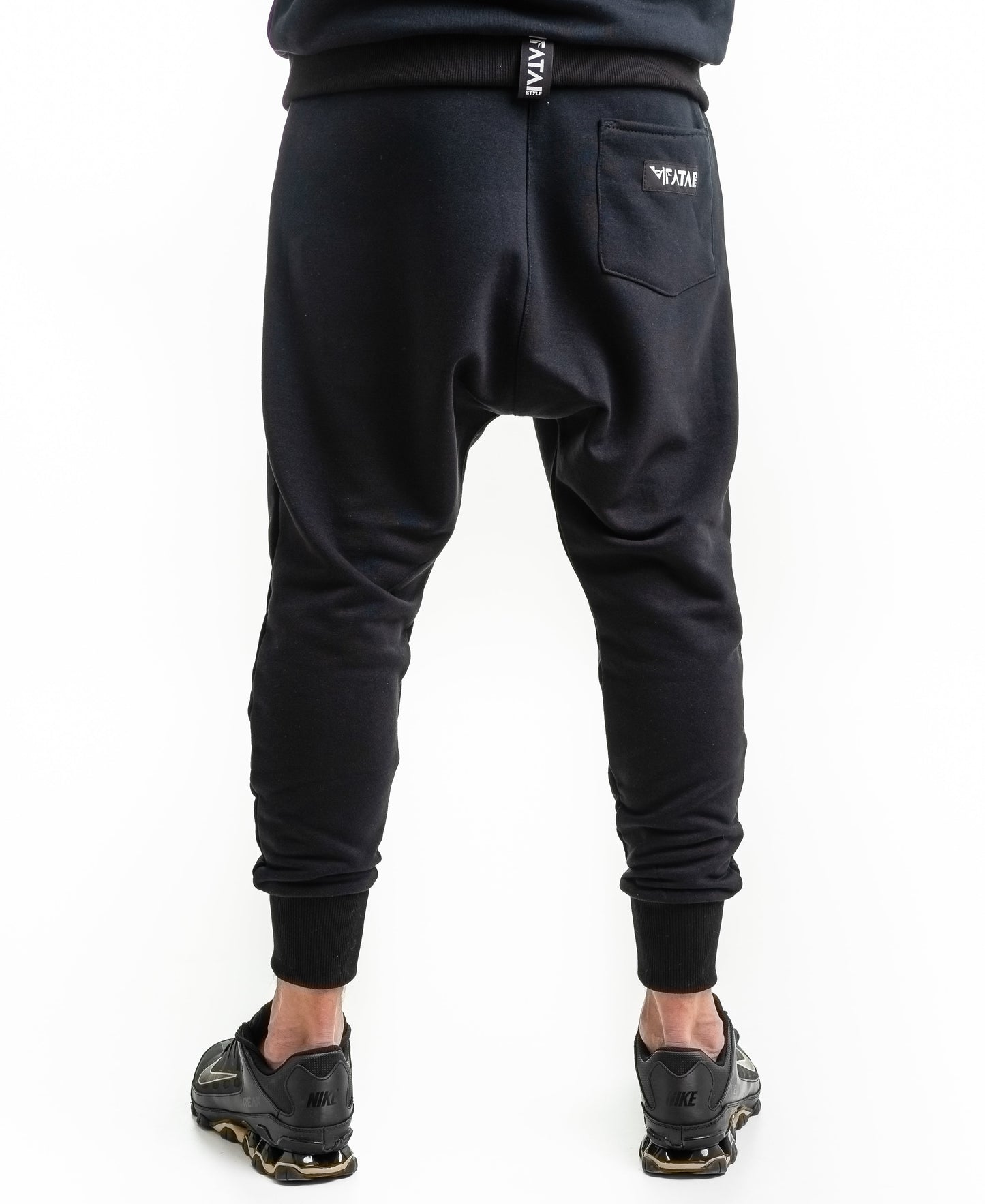 Black trousers with printed text