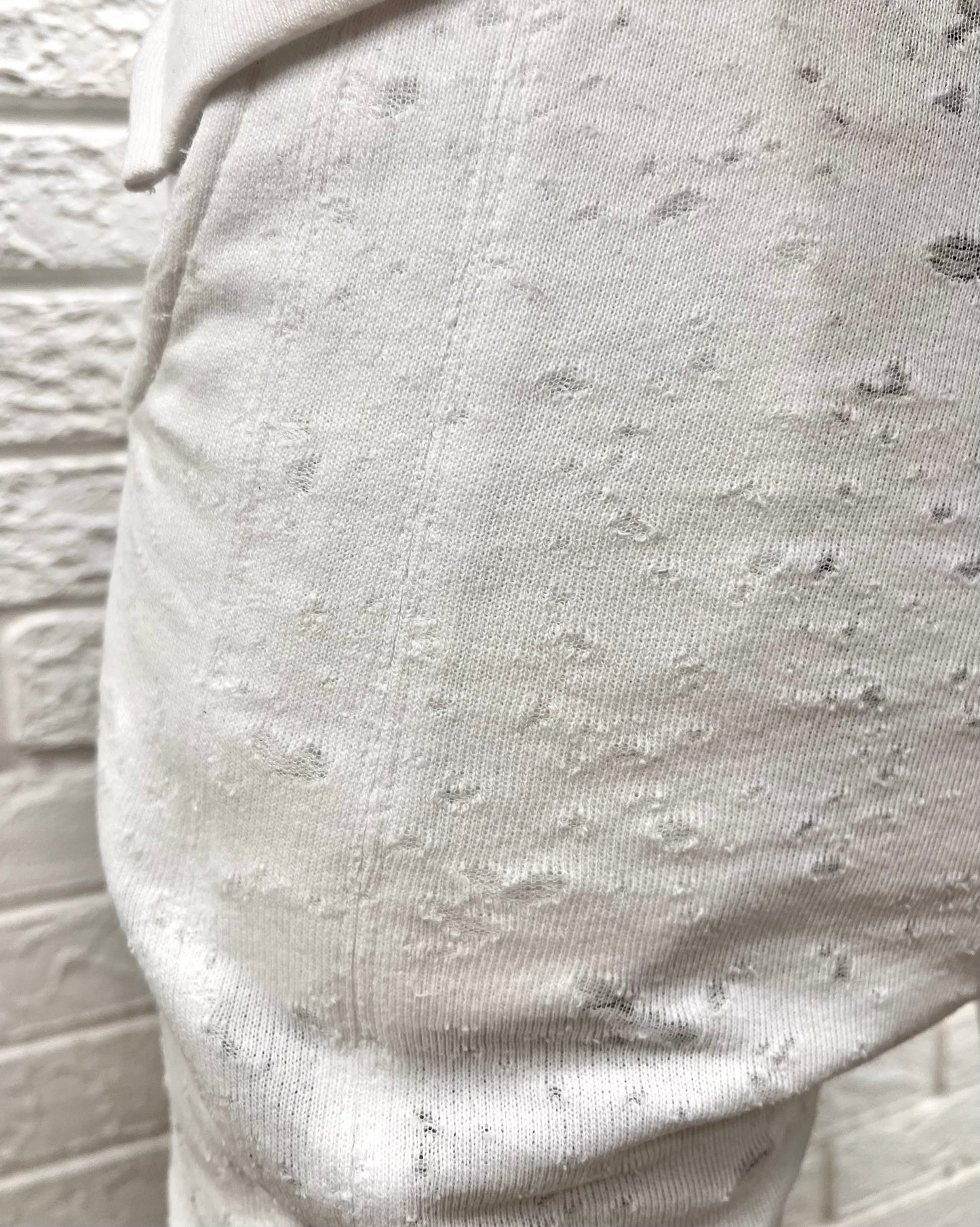 White trousers with special texture and vertical lines as design