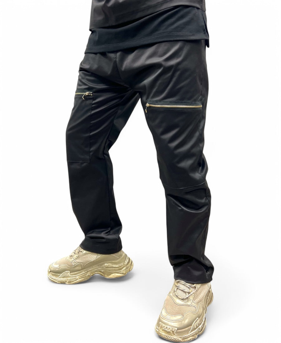 Black trousers made with shiney material, large and with zips