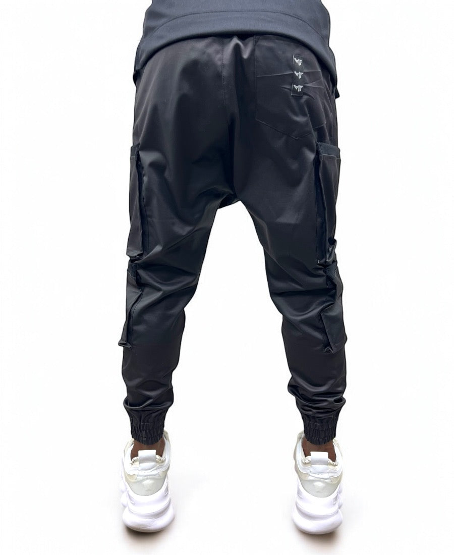 Black trousers made with shiny material and side pockets