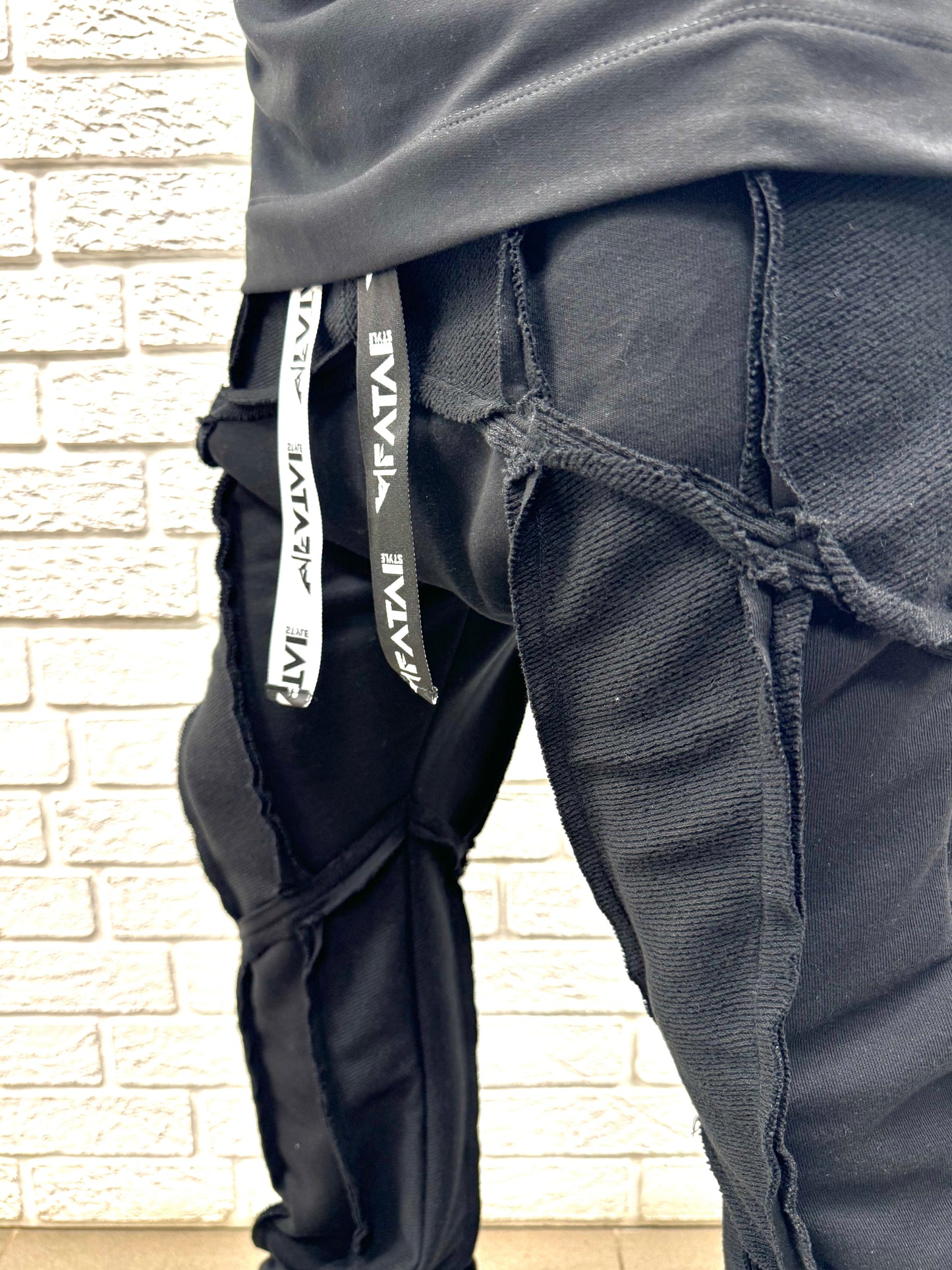 Black trousers with multiple sewings, large