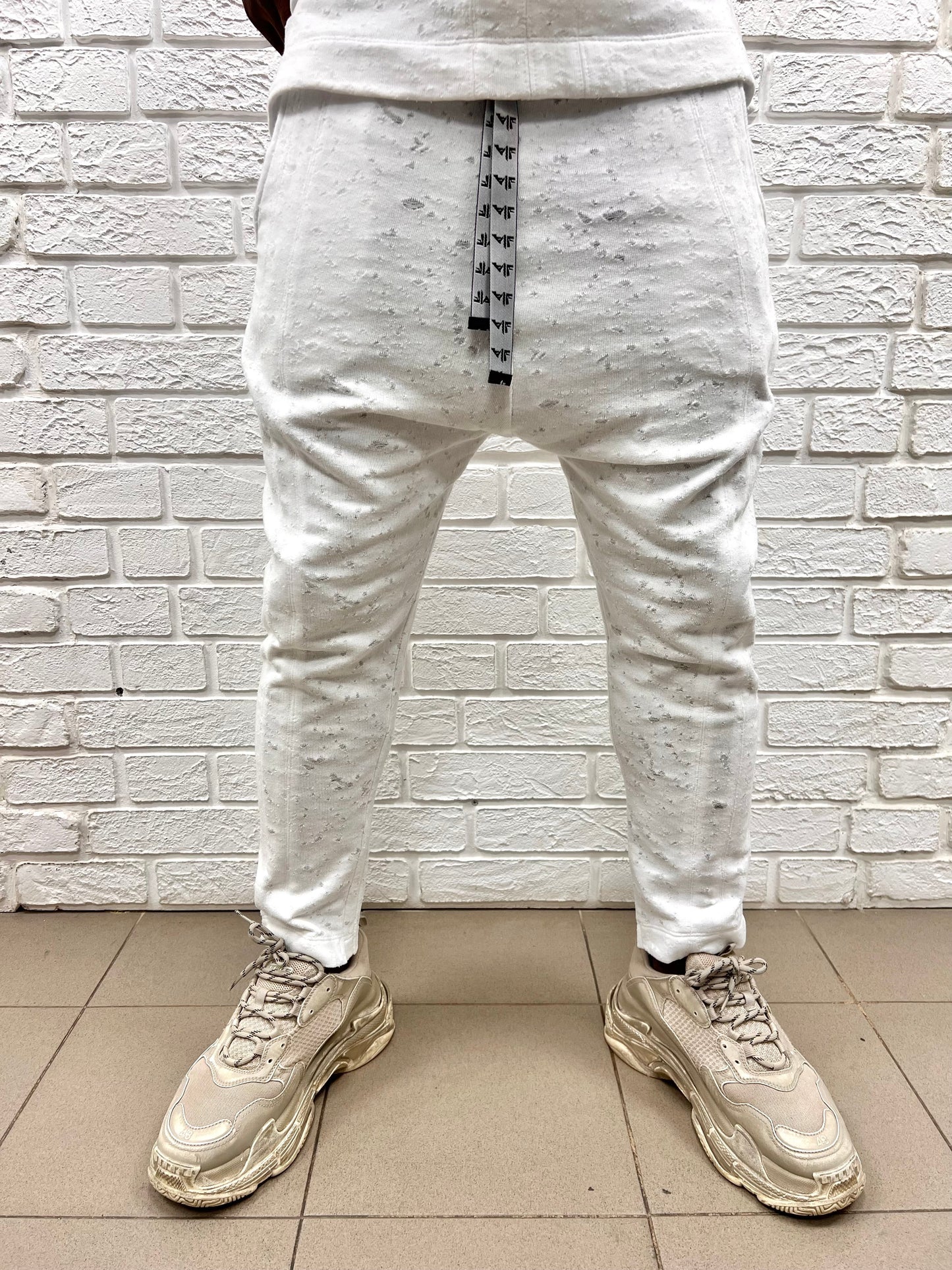 White trousers with special texture and vertical lines as design
