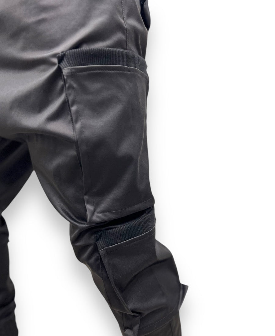 Black trousers made with shiny material and side pockets