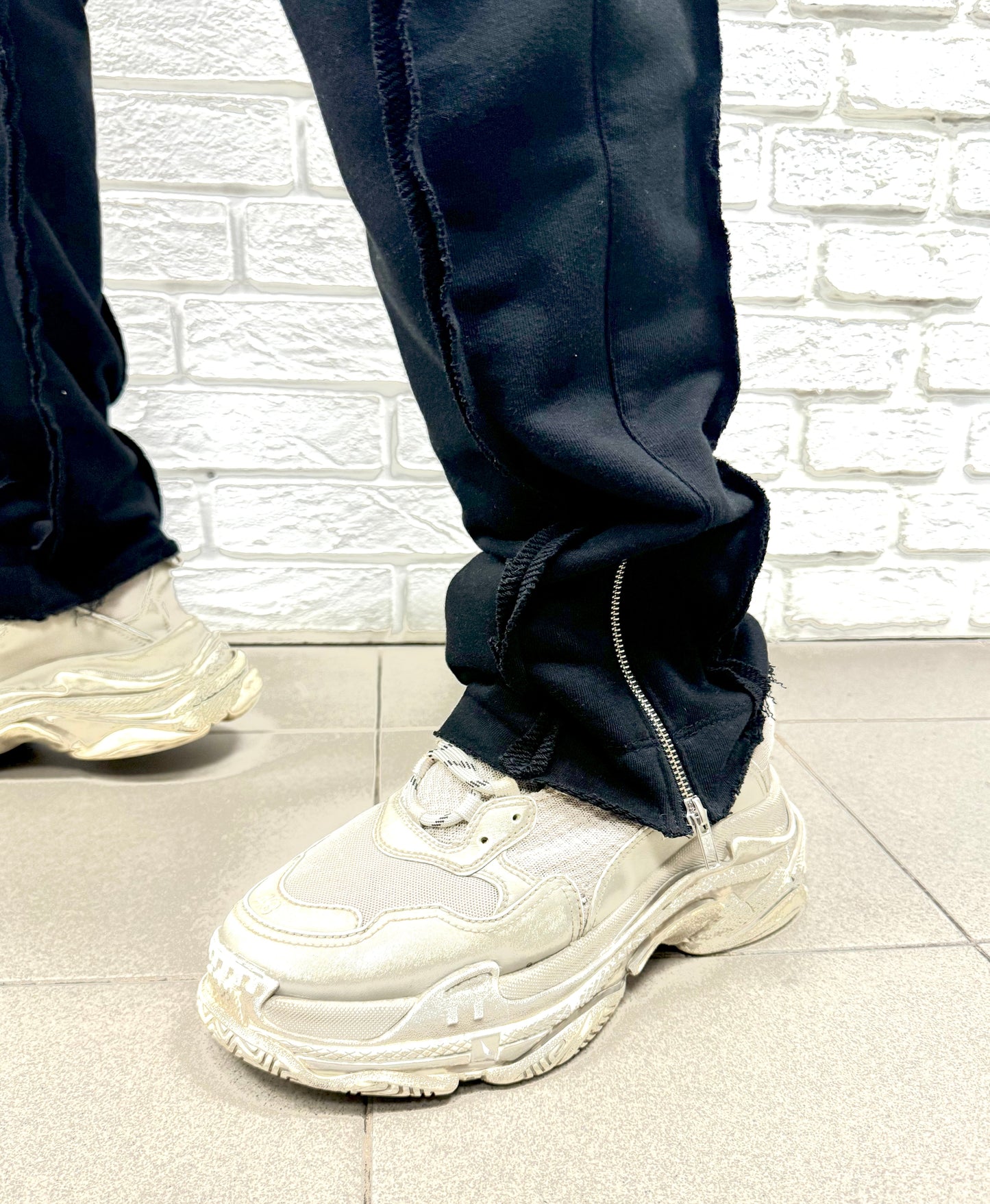 Black trousers with multiple sewings and zips, large