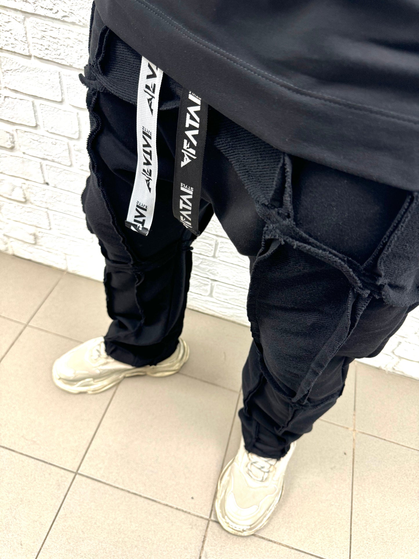 Black trousers with multiple sewings, large