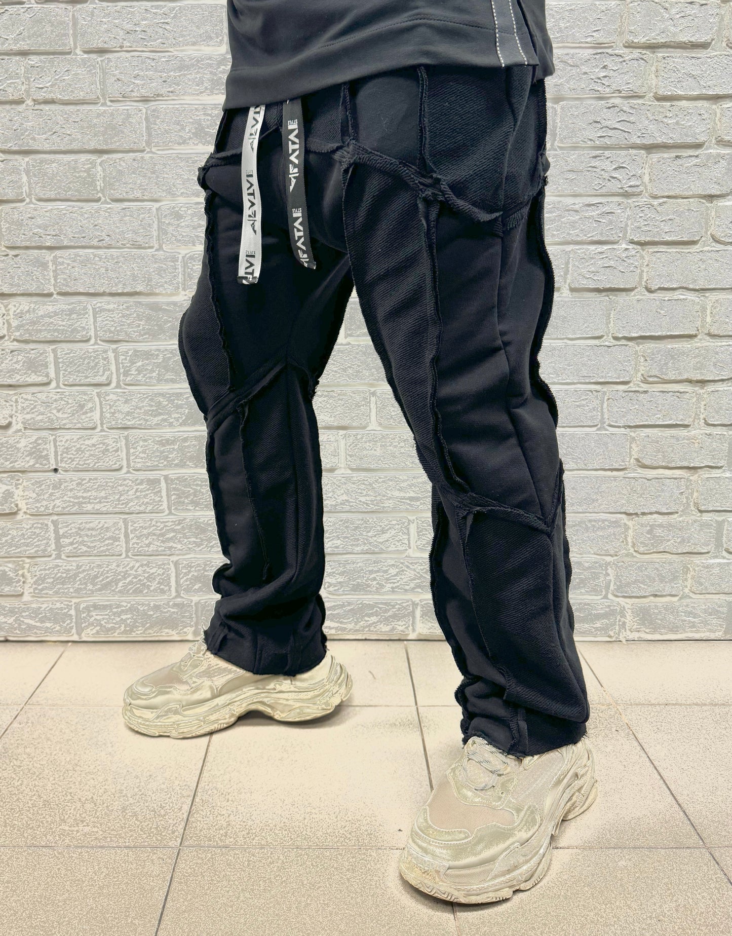 Black trousers with multiple sewings, large