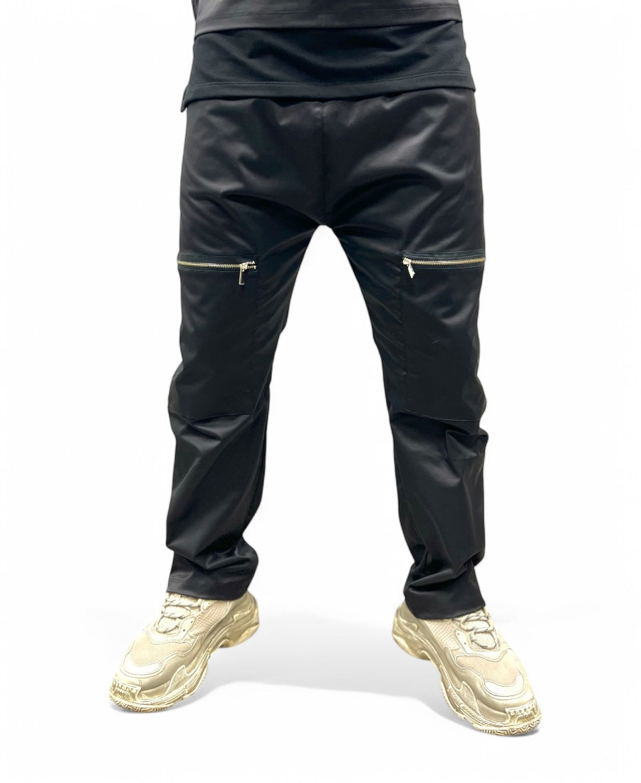 Black trousers made with shiney material, large and with zips