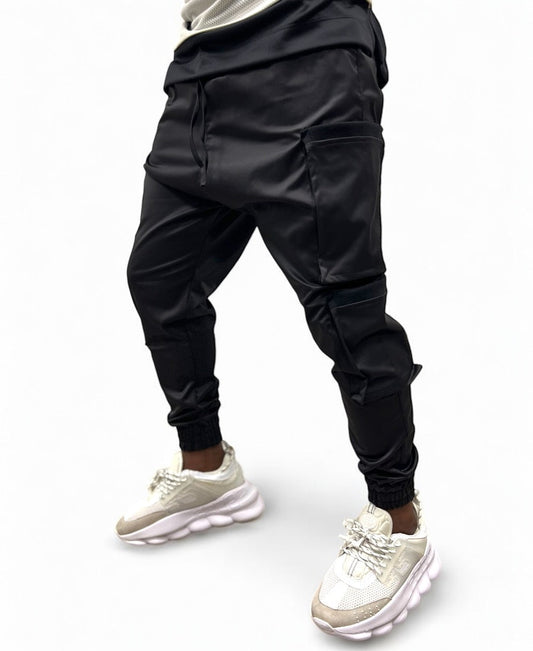 Black trousers made with shiny material and side pockets
