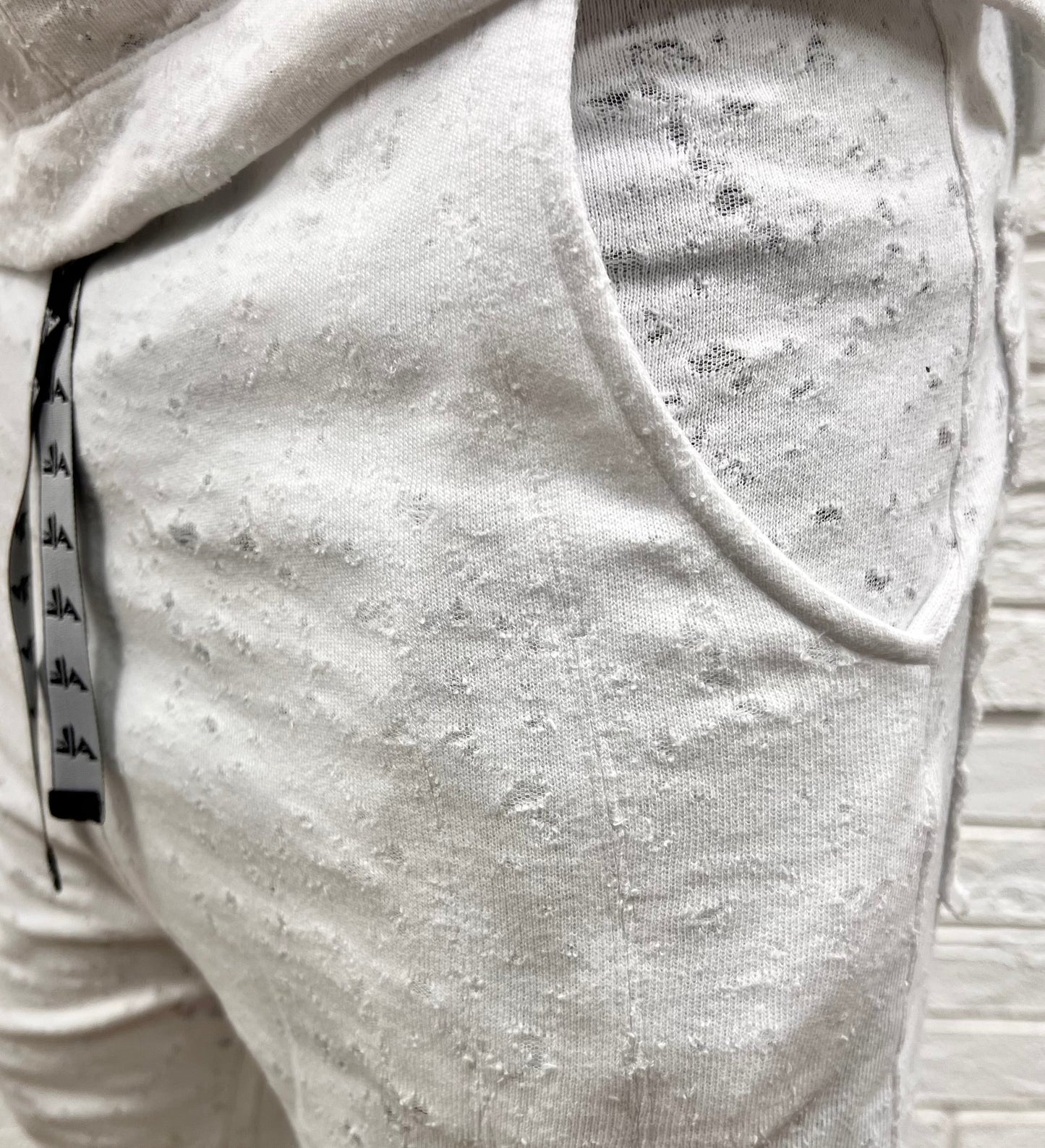 White trousers with special texture and vertical lines as design