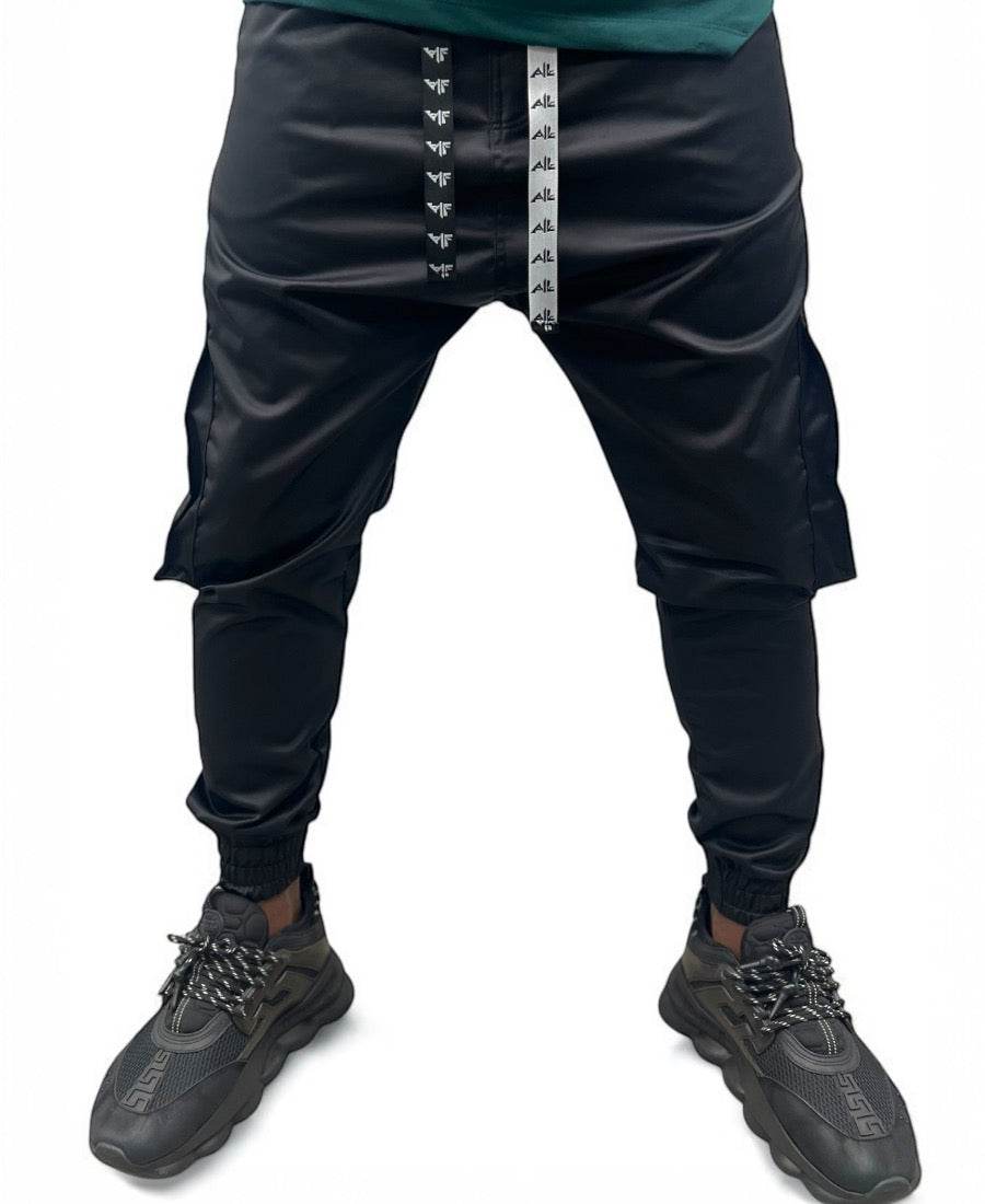 Black trousers made with shiney material and side pockets