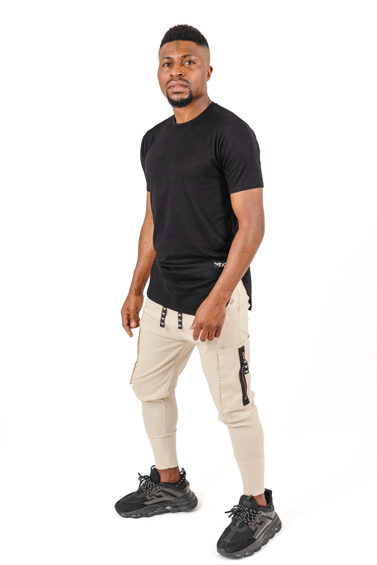 Cream trousers with side pockets and logo