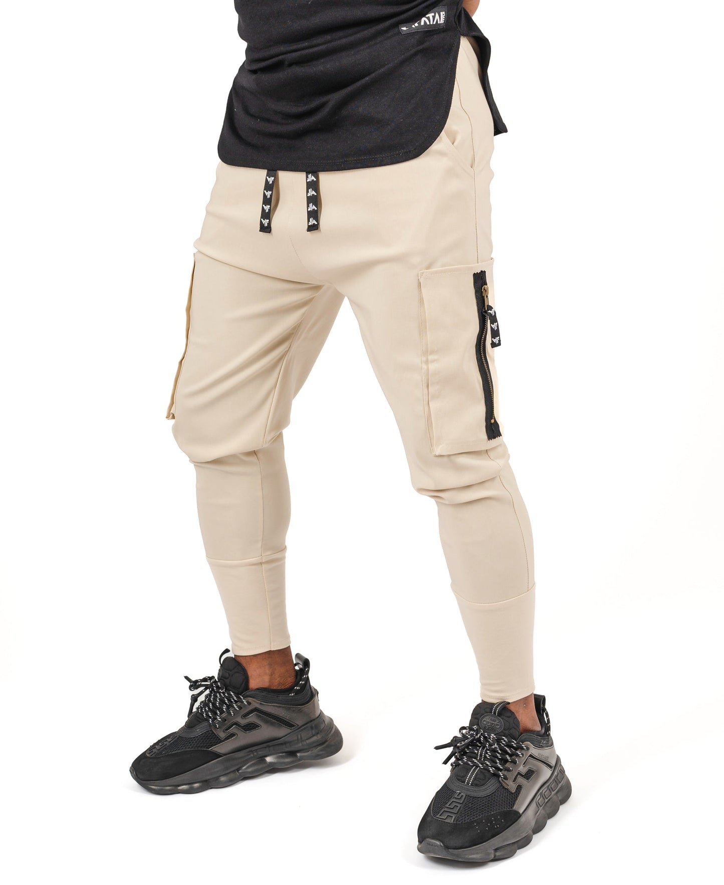 Cream trousers with side pockets and logo