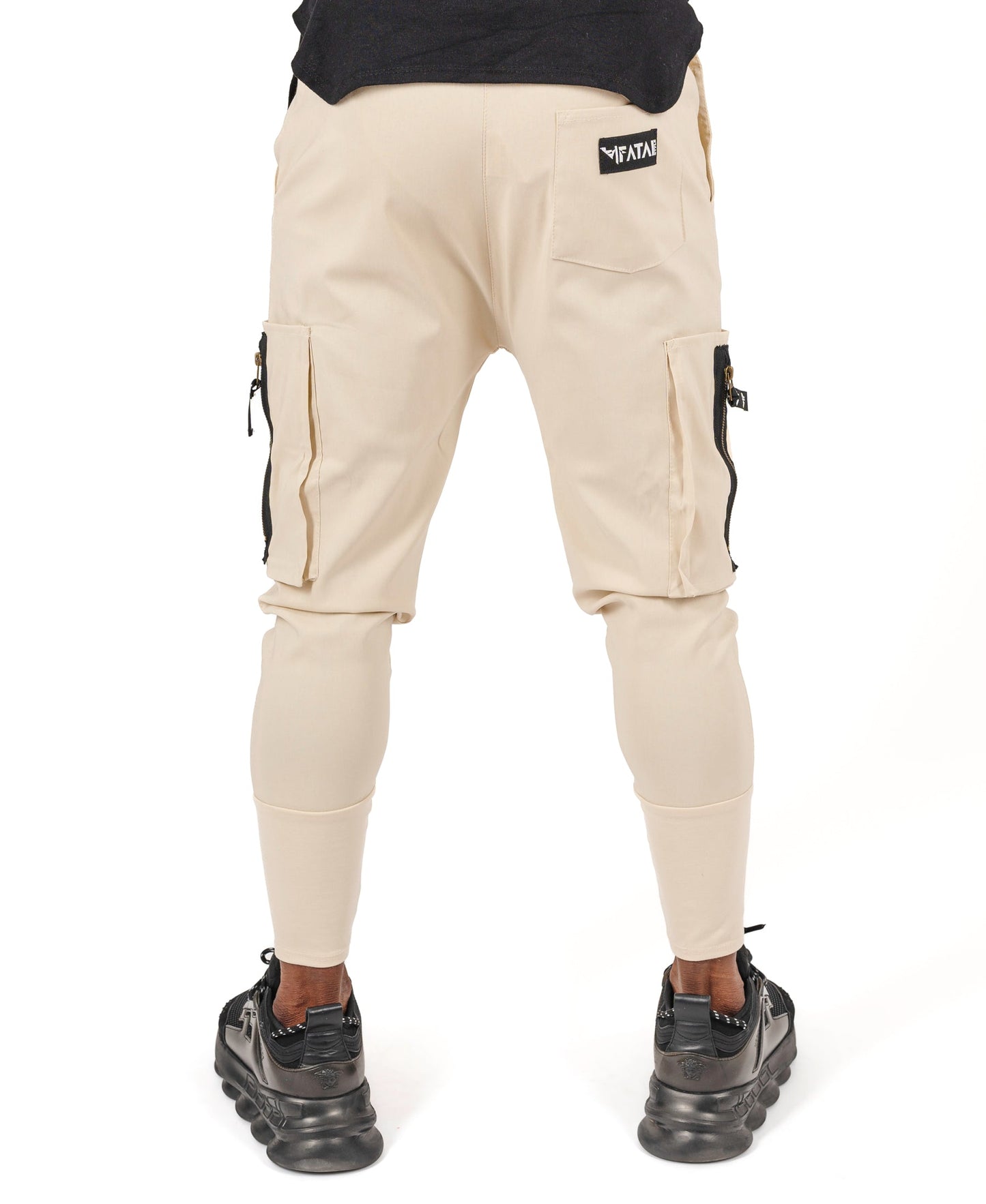 Cream trousers with side pockets and logo