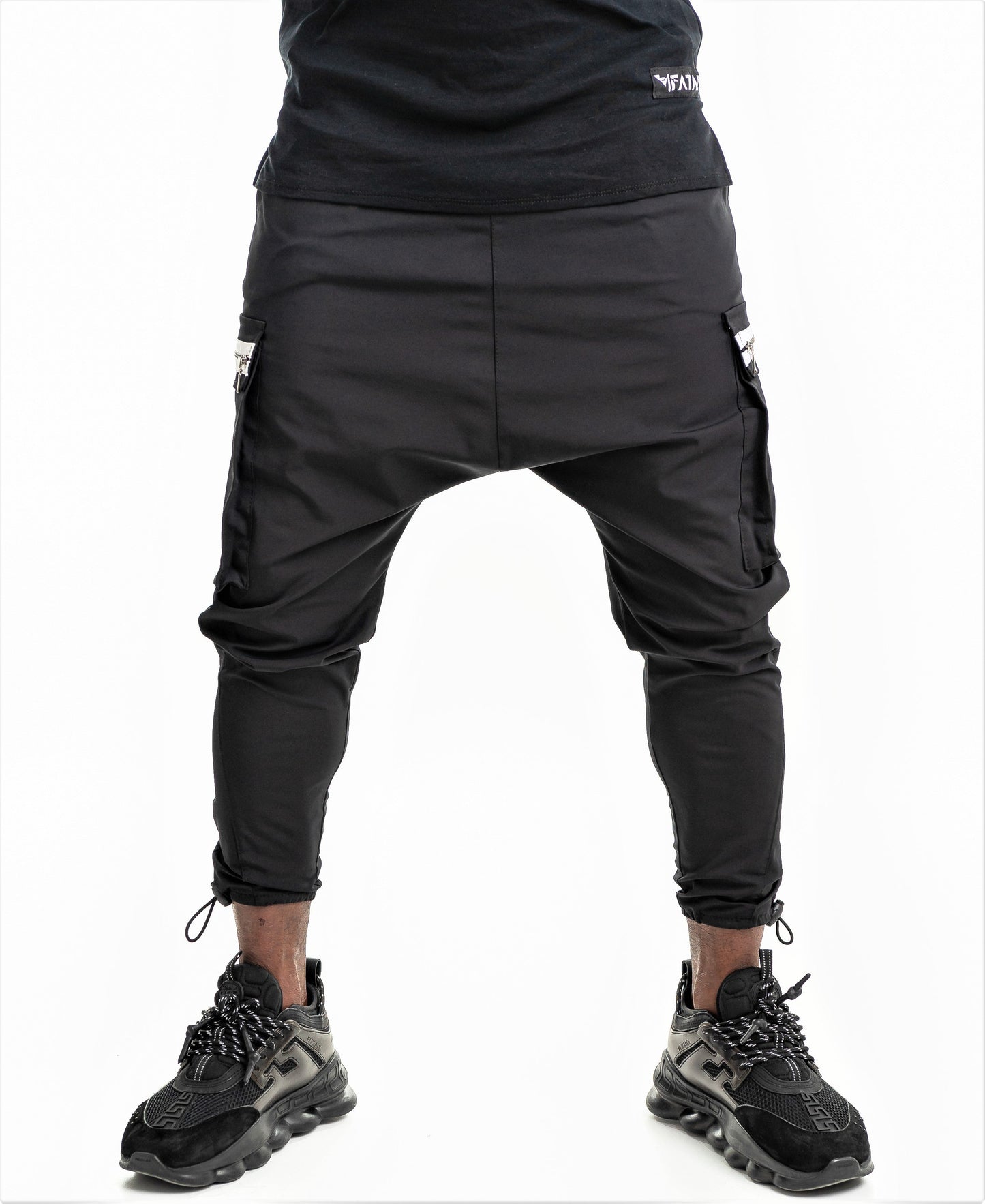 Black trousers with side pockets and white zips