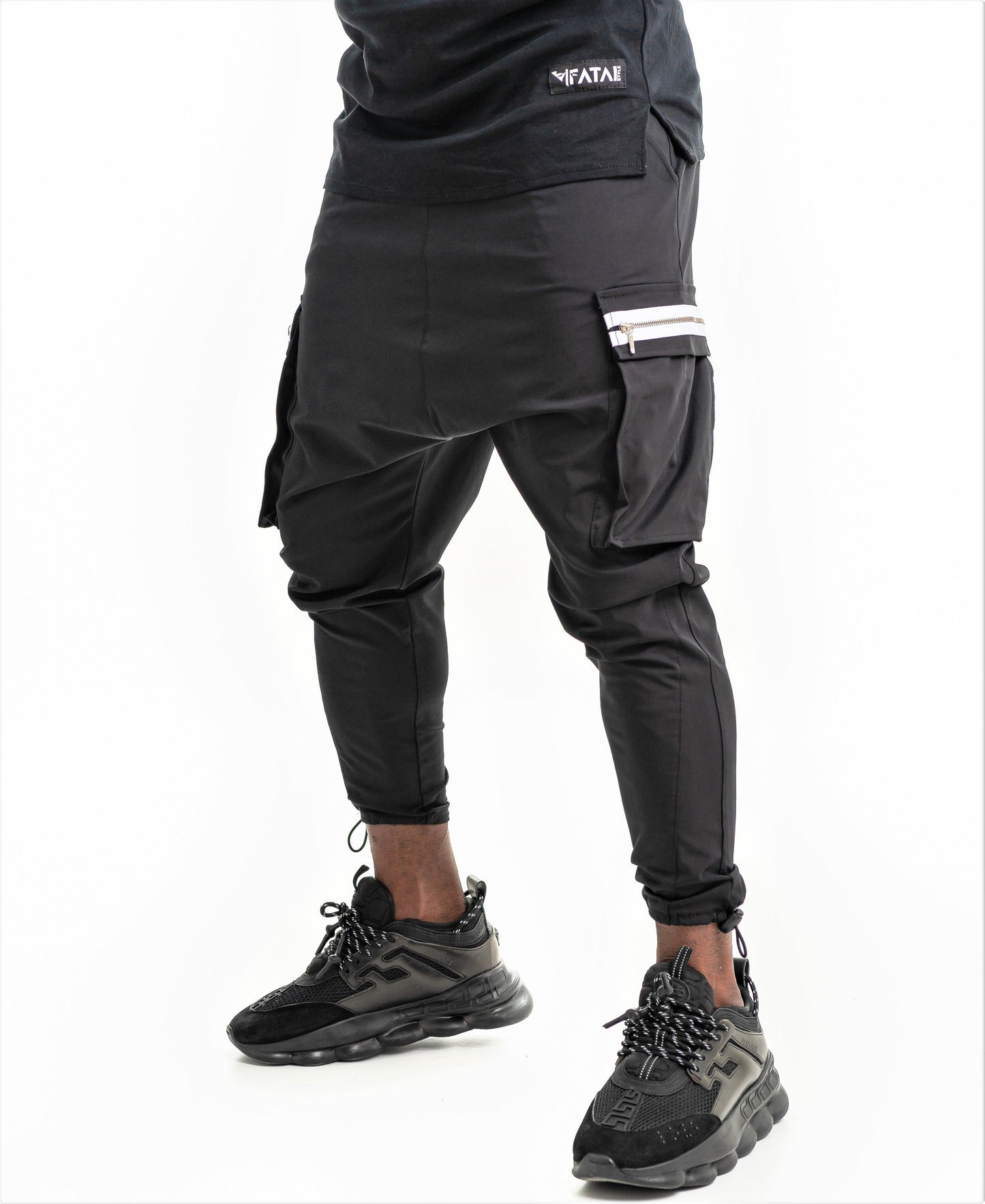 Black trousers with side pockets and white zips
