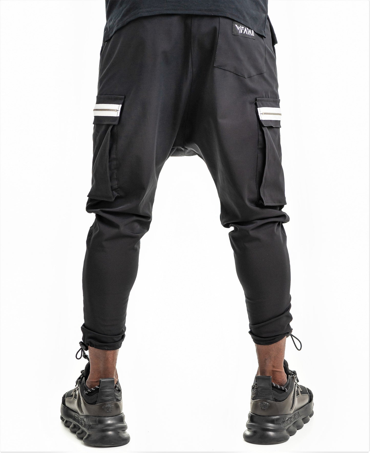 Black trousers with side pockets and white zips