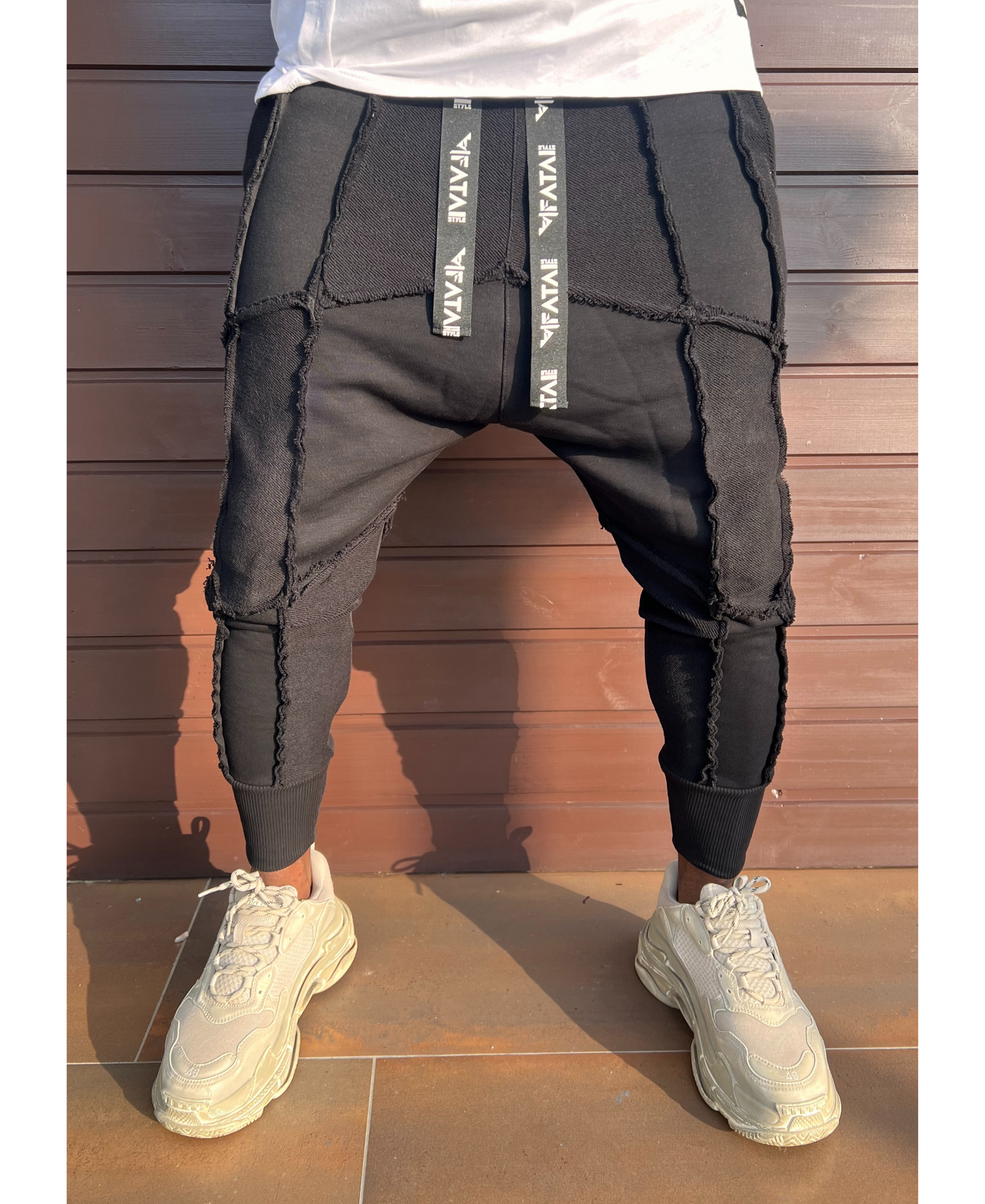 Black trousers with multiple sewings