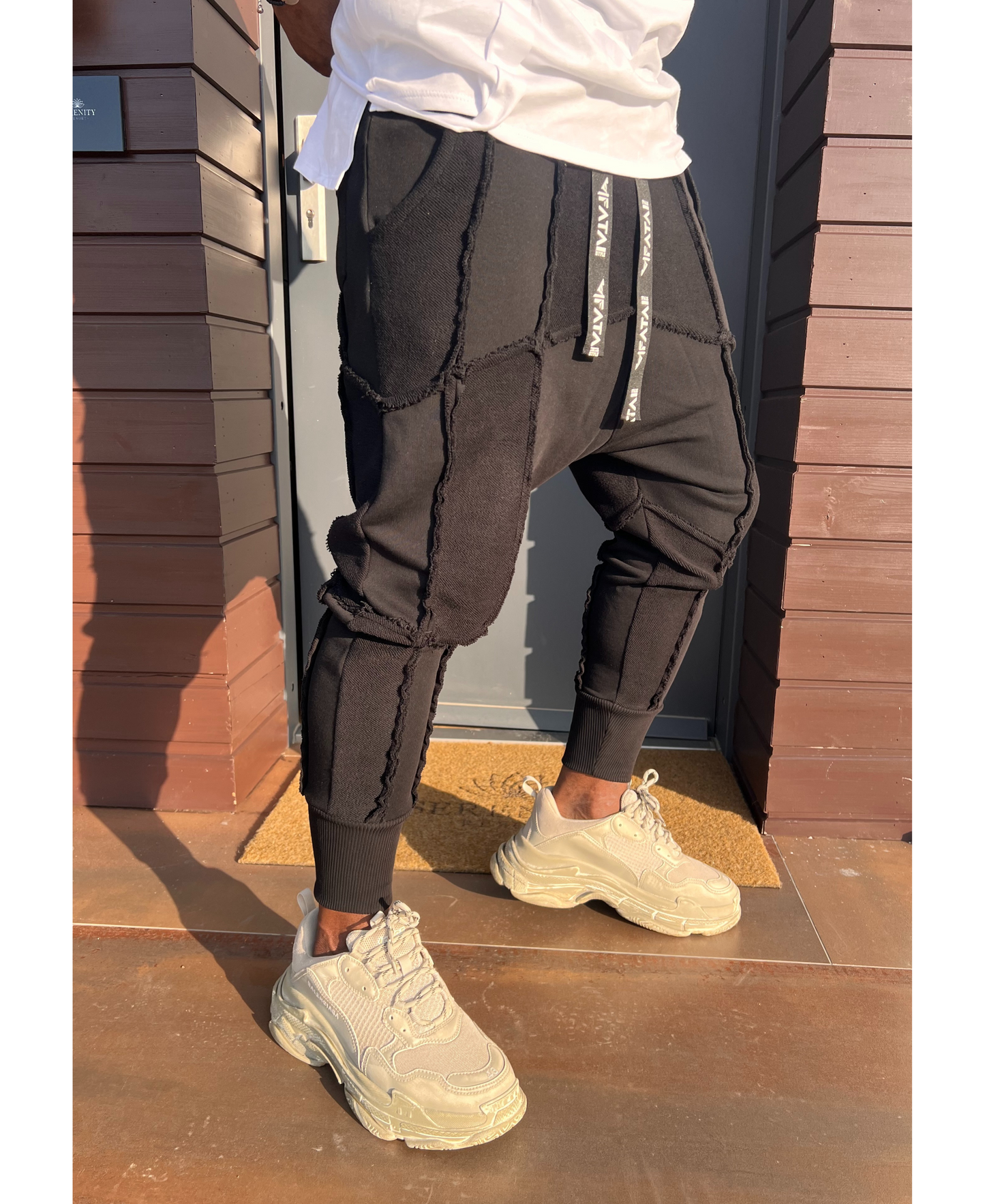 Black trousers with multiple sewings