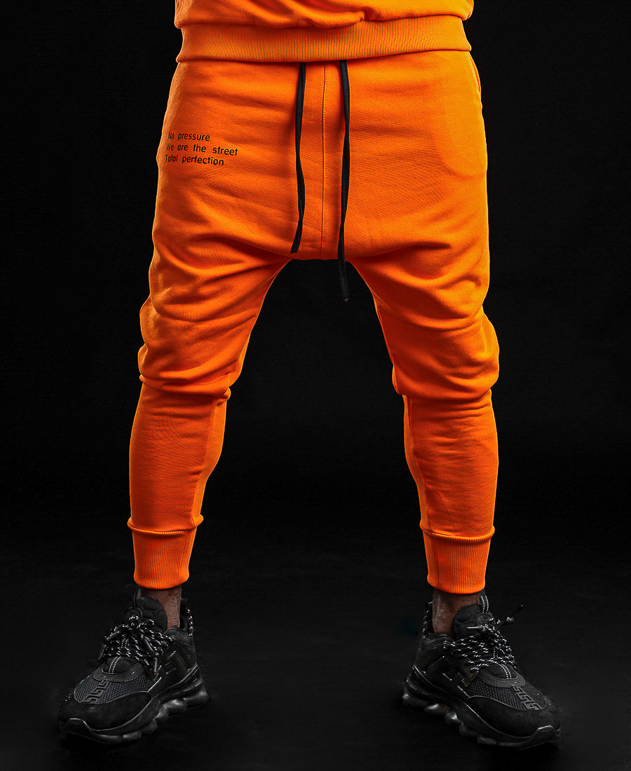 Orange trousers with printed text